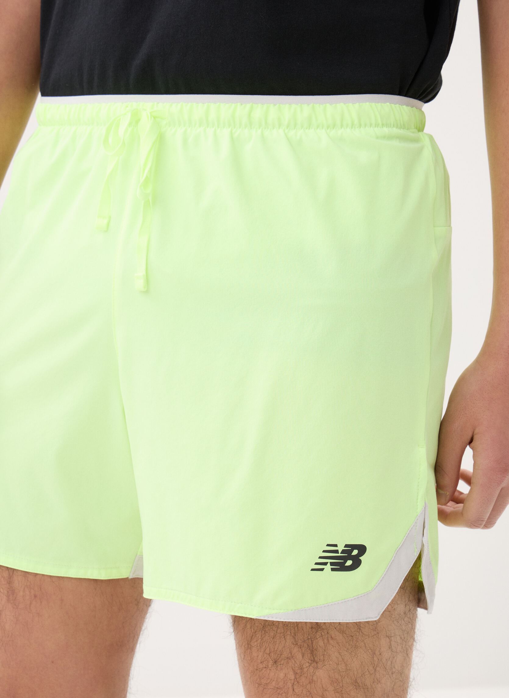 Shorts de sport RC Essential Short 5 homme jaune New Balance Shorts de sport RC Essential Short 5 homme jaune Afterglow